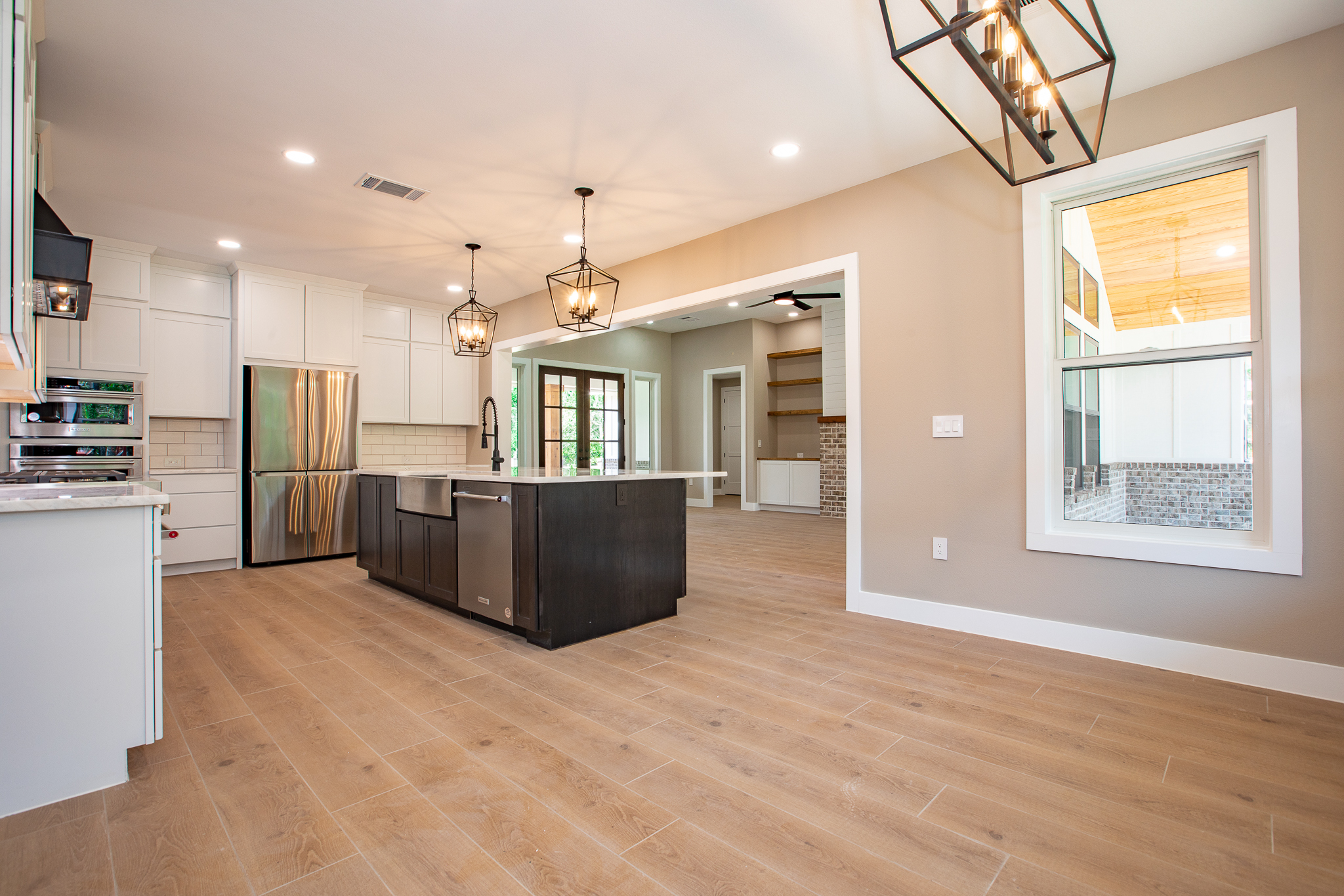 Open-concept living and kitchen space with wood-look flooring