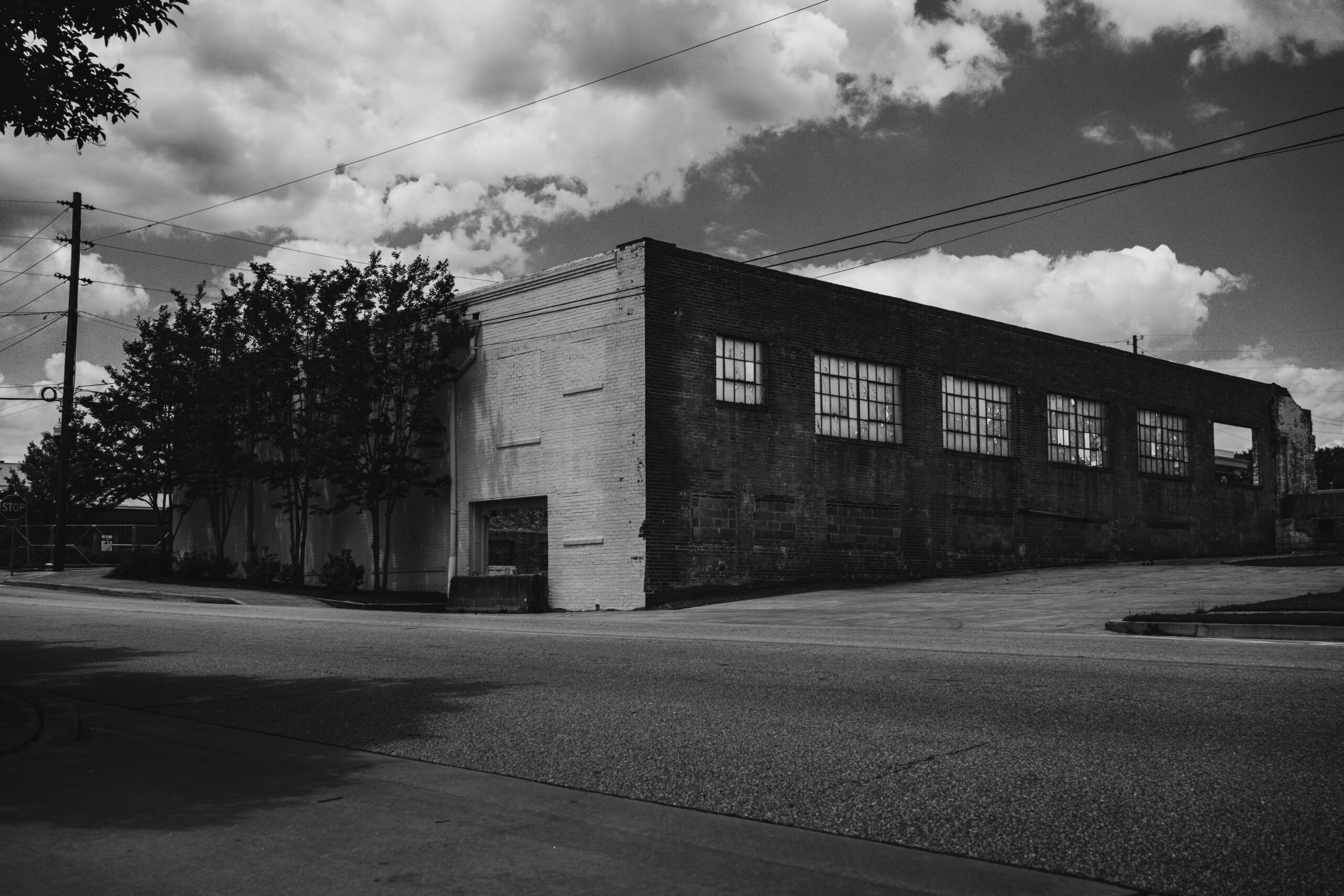 Moody black and white photo of an abandoned urban industrial building.