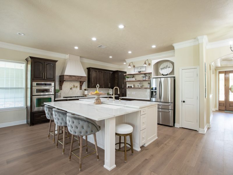Spacious kitchen and dining area with large island and white cabinetry