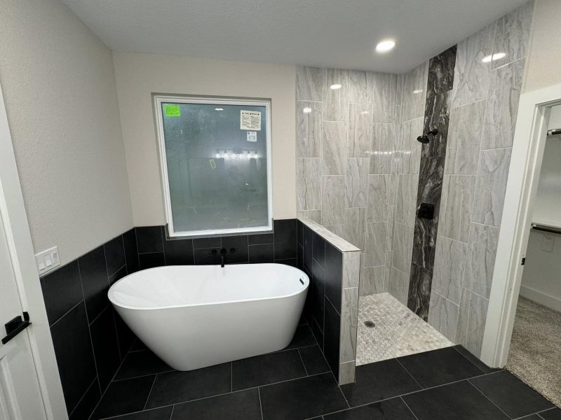 Primary bath with freestanding tub and walk-in shower.