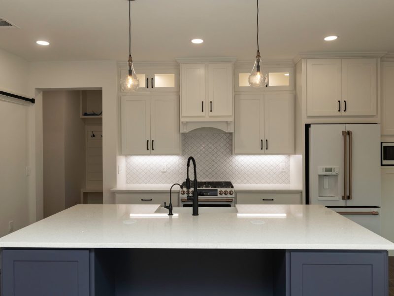 White kitchen with navy island.